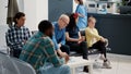 Multiethnic people waiting in hospital reception lobby Royalty Free Stock Photo