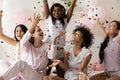 Multiethnic sexy young girls laughing catching falling multi colored confetti