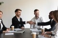 Multiethnic smiling colleagues handshake get acquainted at meeting