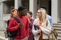 Multiethnic student friends walking in college campus Royalty Free Stock Photo