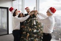 Multiethnic team of people putting christmas tree decor in festive office Royalty Free Stock Photo