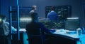 Team of IT technical specialists and software programmers work in monitoring office Royalty Free Stock Photo