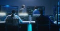 Team of IT technical specialists and software programmers work in monitoring office Royalty Free Stock Photo