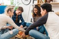 multiethnic teen friends sitting on floor