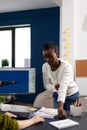 Multiethnic women designer looking at computer with dual displays