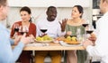 Multiethnic women and men friends chatting and drinking Royalty Free Stock Photo