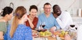 Multiethnic women and men friends chatting and drinking Royalty Free Stock Photo