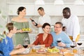 Multiethnic women and men friends chatting and drinking Royalty Free Stock Photo
