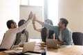 Multiethnic work team give high five motivated for shared success Royalty Free Stock Photo