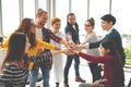 Multiethnic young team stack hands together as unity and teamwork in modern office. Diverse group togetherness collaboration Royalty Free Stock Photo