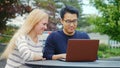 Multiethnicity young friends working with laptop.