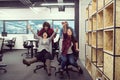 Multiethnics business team racing on office chairs