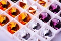 Multifaceted gem crystal jewelry many material bright colors close up for handmade on white background
