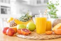 Multifruit juice and fresh fruit on table on kitchen background