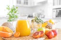 Multifruit juice and fresh fruit on table on kitchen background