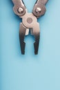 Multifunctional tool close-up on a blue background. The concept of a pocket tool with free space. Royalty Free Stock Photo