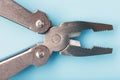 Multifunctional tool close-up on a blue background. The concept of a pocket tool with free space Royalty Free Stock Photo