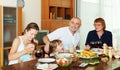 Multigeneration family communicate over holiday table Royalty Free Stock Photo