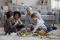 Multigenerational family play wooden railway at home Royalty Free Stock Photo