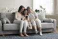 Multigenerational women family spend leisure on internet using cellphone Royalty Free Stock Photo