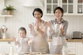 Multigenerational women family having fun while cooking in kitchen Royalty Free Stock Photo