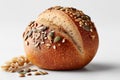 Multigrain bread roll with seeds resting on clean white backdrop. Simple aesthetic highlights texture and freshness Royalty Free Stock Photo