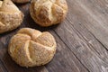 Multigrain Kaiser rolls on wooden background