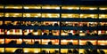 Multilevel parking garage with cars parked inside at night.