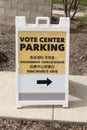 A multilingual voting center parking sign with arrow Royalty Free Stock Photo