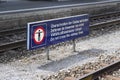 Multilingual warning sign at the railroad station platform Royalty Free Stock Photo