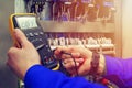 Multimeter in hands of electrician close-up against background of electrical wires and relays Royalty Free Stock Photo