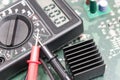 Multimeter on PCB plate. Royalty Free Stock Photo