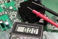 Multimeter on PCB plate. Royalty Free Stock Photo