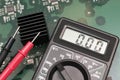 Multimeter on PCB plate. Royalty Free Stock Photo