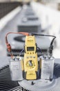 Multimeter and run capacitors on condenser vertical background Royalty Free Stock Photo