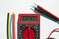 Multimeter with text on display Electric and heat shrink insulation on white background
