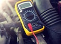 Multimeter or voltmeter testing car battery Royalty Free Stock Photo