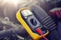 Multimeter or voltmeter testing car battery Royalty Free Stock Photo