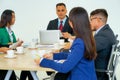 Multinational businessmen and businesswomen different race having conference at meeting table in office with white background.