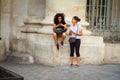 A multinational couple of girls is checking with a map and a smartphone on Pantheon Square in Paris, the journey of two