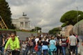 Multinational crowd of tourists on a pedestrian street in the center of Rome walk to the altar of the Fatherland or Vittoriano,