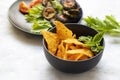 Multinational cuisine. Bowl with tasty Mexican nachos chips on white background. corn chips nachos with fried bitter gourd served Royalty Free Stock Photo
