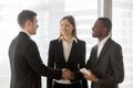 Multinational entrepreneurs handshaking in office Royalty Free Stock Photo