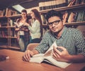 Multinational group of cheerful students studying in the university library. Royalty Free Stock Photo