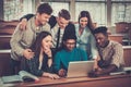 Multinational group of cheerful students taking an active part in a lesson while sitting in a lecture Hall. Royalty Free Stock Photo