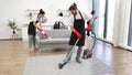 Multinational group of cleaners cleans bright studio kitchen.