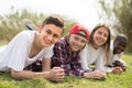 multinational modern teens lie in the park on the grass Royalty Free Stock Photo