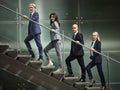 Multiethnic business people walking on steps in modern office Royalty Free Stock Photo