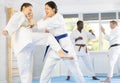 Multinational pupils train to perform defensive karate installations and attacking combat techniques