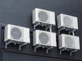 Multiple Air Conditioning Units Mounted at Black Brick Wall Royalty Free Stock Photo